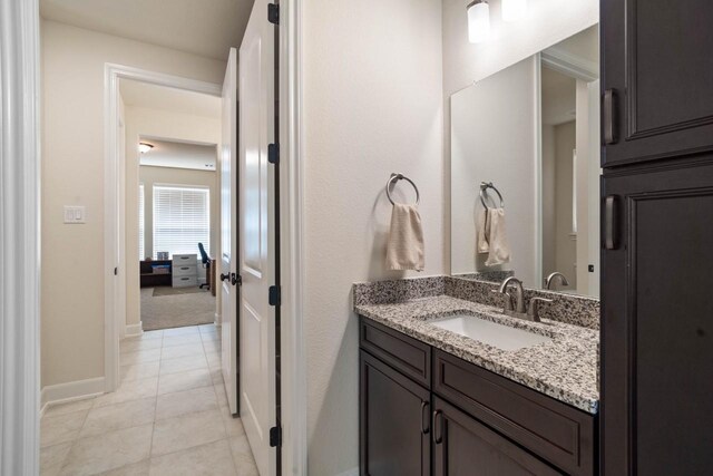 bathroom featuring baseboards, vanity, and tile patterned flooring
