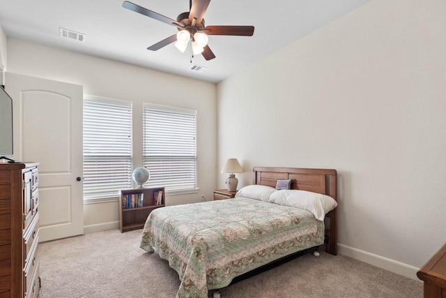 bedroom featuring baseboards, visible vents, and light colored carpet