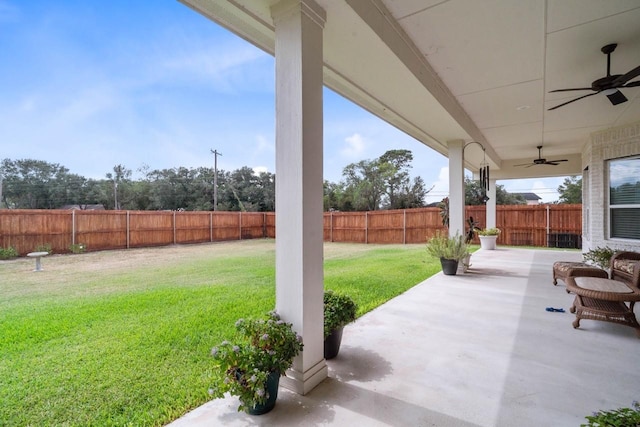 view of yard featuring a fenced backyard, a ceiling fan, and a patio