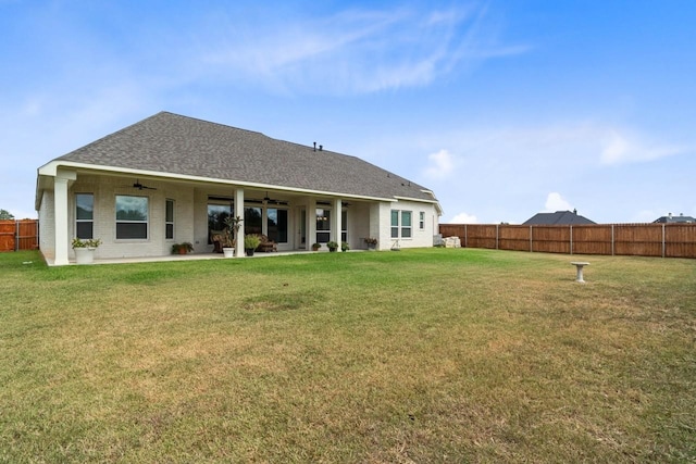 rear view of house featuring a fenced backyard, a shingled roof, ceiling fan, a patio, and a lawn