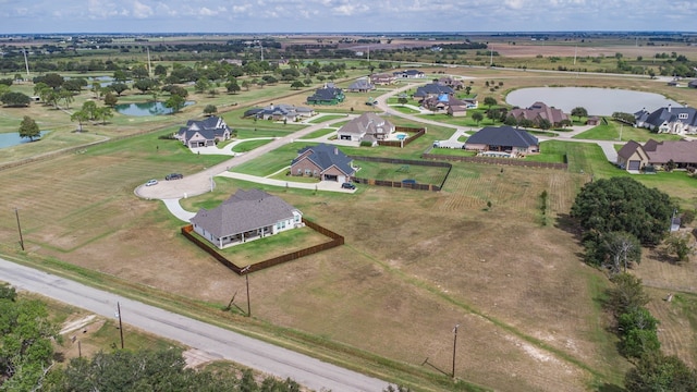 drone / aerial view with a water view and a rural view