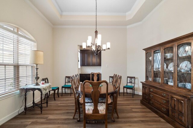 dining room featuring a wealth of natural light, a notable chandelier, and a tray ceiling