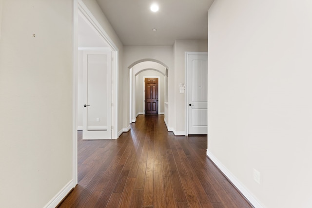 corridor with dark hardwood / wood-style floors