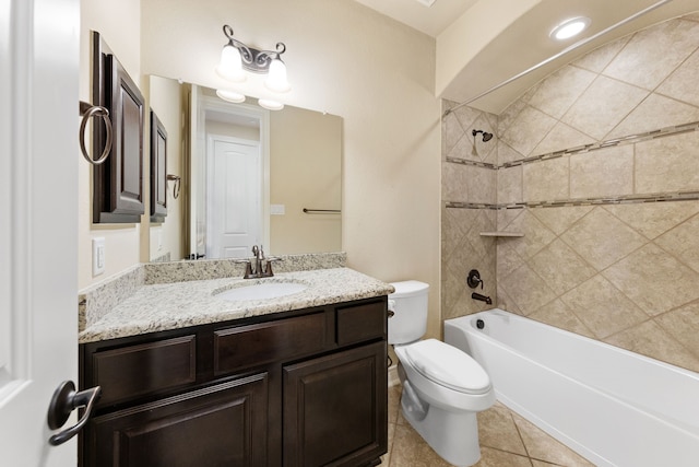 full bathroom featuring vanity, tiled shower / bath combo, toilet, and tile patterned floors