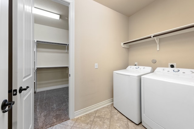 laundry room featuring light tile patterned floors and washing machine and clothes dryer