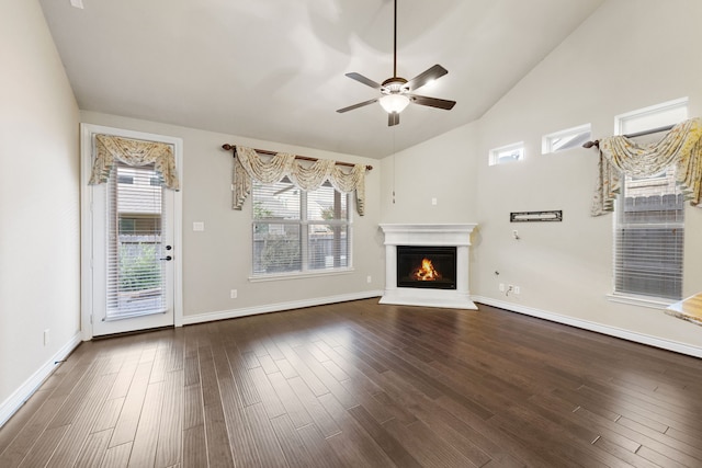 unfurnished living room with high vaulted ceiling, ceiling fan, and dark wood-type flooring