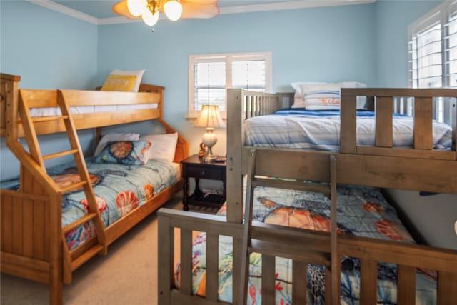 bedroom featuring ornamental molding, ceiling fan, and carpet floors