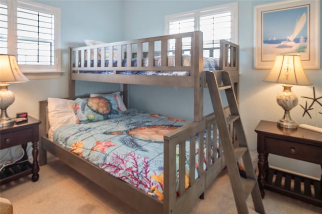 bedroom with multiple windows and carpet flooring