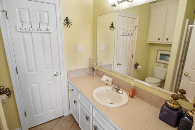 bathroom with vanity, toilet, and tile patterned floors