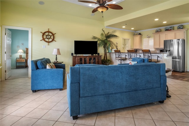 tiled living room featuring ornamental molding and ceiling fan