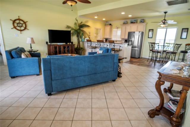 tiled living room featuring ceiling fan