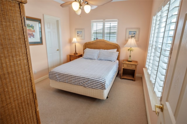 bedroom featuring light carpet and ceiling fan