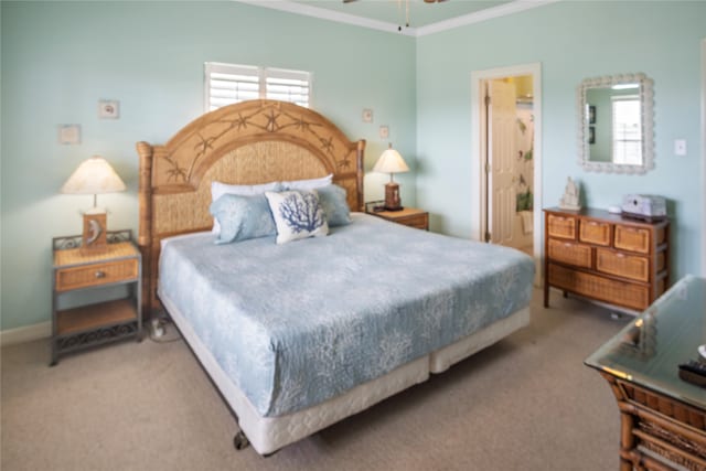 carpeted bedroom with connected bathroom and crown molding