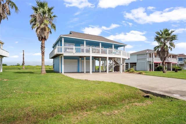 rear view of property featuring a lawn and a garage