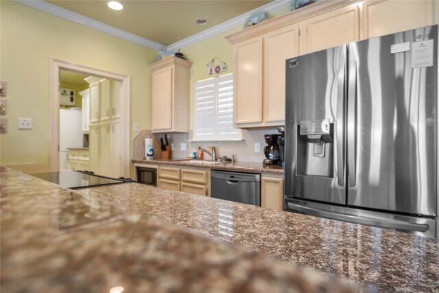 kitchen featuring decorative backsplash, black appliances, dark stone counters, ornamental molding, and sink