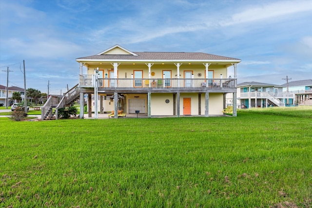 rear view of house with a yard and a wooden deck