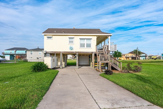 view of front of property with a garage, a carport, a front lawn, and covered porch