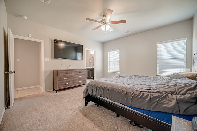 bedroom with connected bathroom, ceiling fan, and light colored carpet