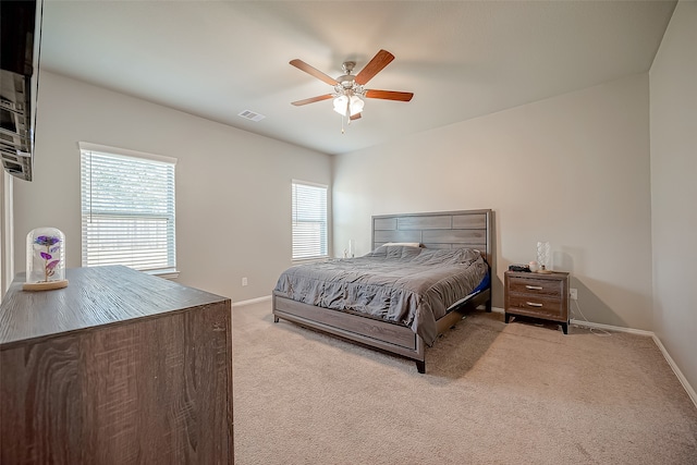 bedroom with ceiling fan and light colored carpet