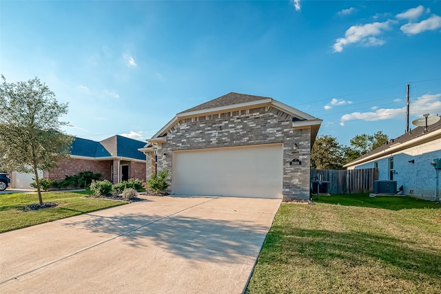 view of front facade featuring a front yard, cooling unit, and a garage