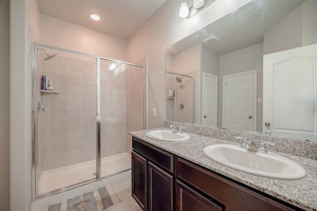 bathroom featuring vanity and an enclosed shower