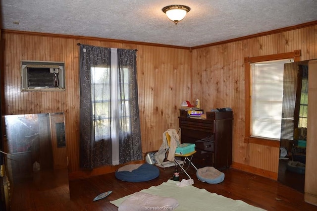 misc room with crown molding, wooden walls, dark hardwood / wood-style floors, and an AC wall unit