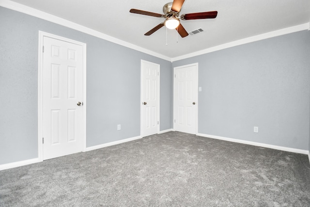 carpeted spare room with ornamental molding and ceiling fan