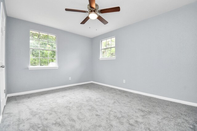 carpeted empty room featuring ceiling fan