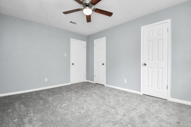 spare room featuring carpet and ceiling fan