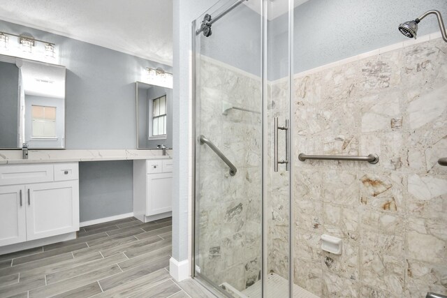 bathroom with walk in shower and vanity