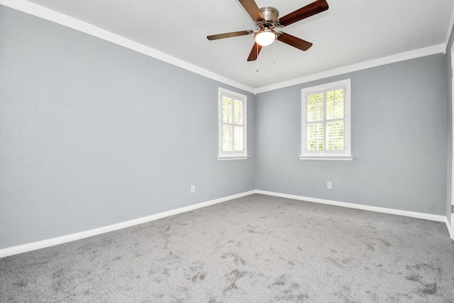 carpeted empty room with ceiling fan and crown molding