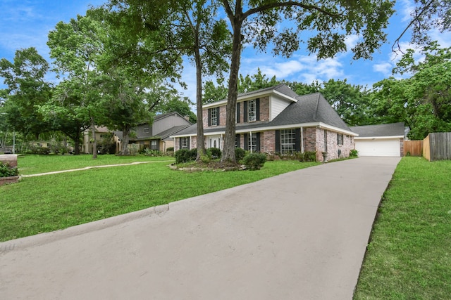 view of front of house featuring a garage and a front lawn