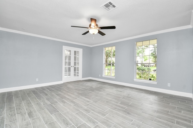 empty room featuring light hardwood / wood-style flooring, ceiling fan, ornamental molding, and a textured ceiling