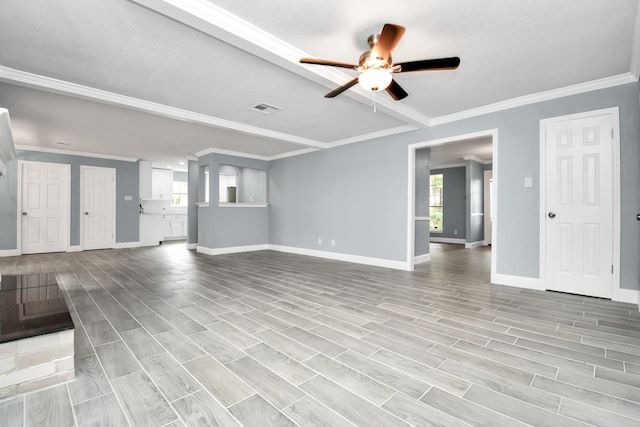 unfurnished living room featuring ornamental molding, light wood-type flooring, ceiling fan, and a textured ceiling