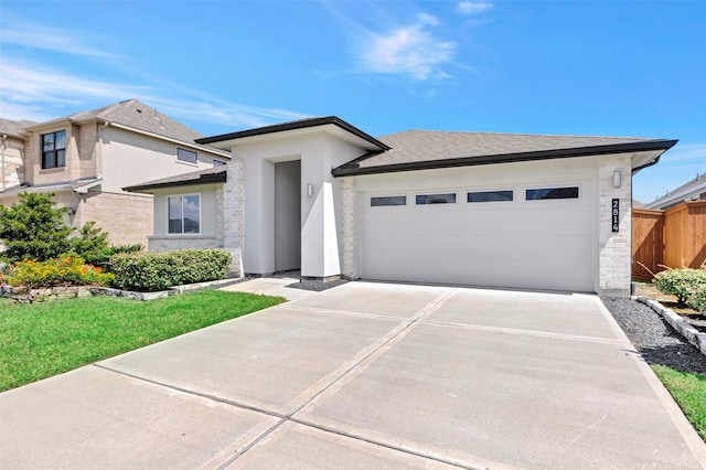 view of front of property featuring a garage and a front yard