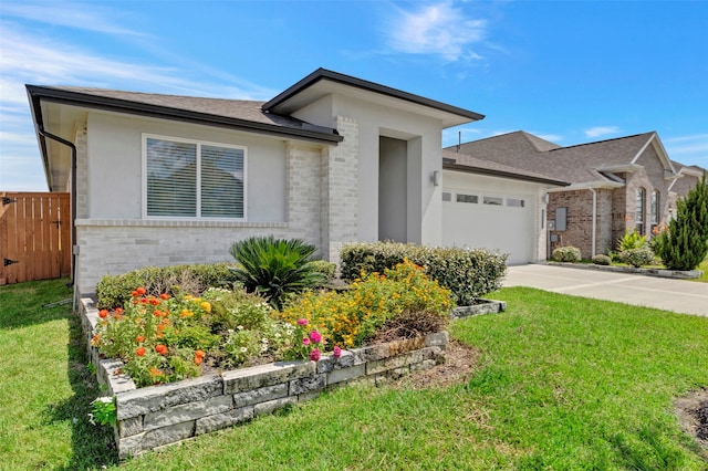 view of front of home with a garage and a front lawn