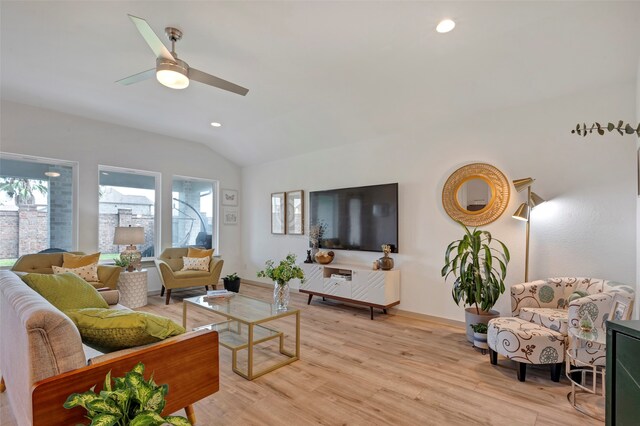 living room featuring ceiling fan, light hardwood / wood-style flooring, and lofted ceiling