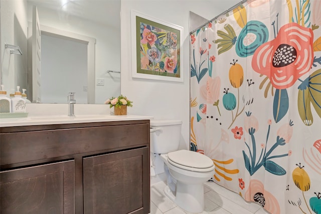 bathroom with a shower with curtain, vanity, toilet, and tile patterned floors