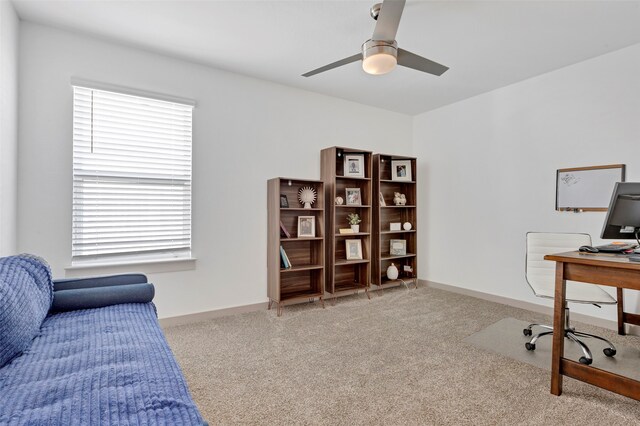 carpeted office space featuring ceiling fan