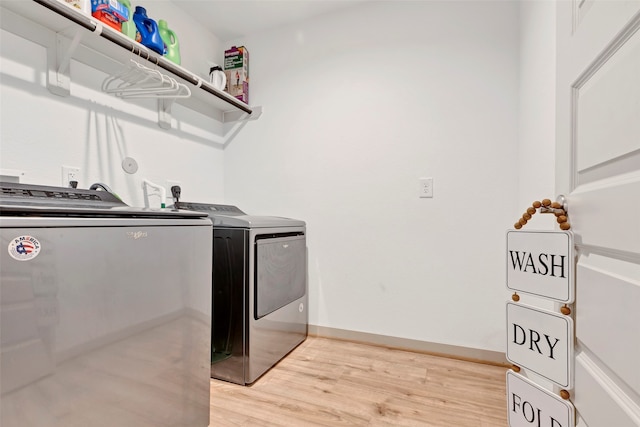 laundry room featuring light wood-type flooring and washing machine and dryer