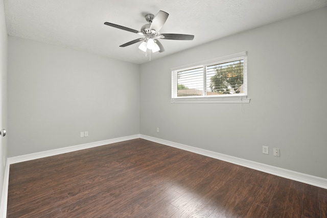 unfurnished room with ceiling fan, a textured ceiling, and dark wood-type flooring