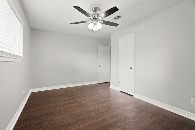 spare room with ceiling fan and dark hardwood / wood-style floors