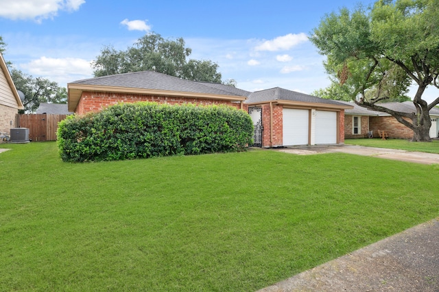 ranch-style house with a garage, a front lawn, and central AC