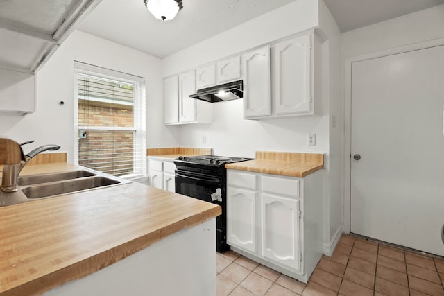 kitchen featuring light tile patterned floors, sink, electric range, and white cabinetry