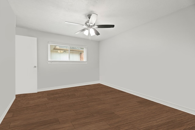 spare room featuring ceiling fan, dark hardwood / wood-style floors, and a textured ceiling