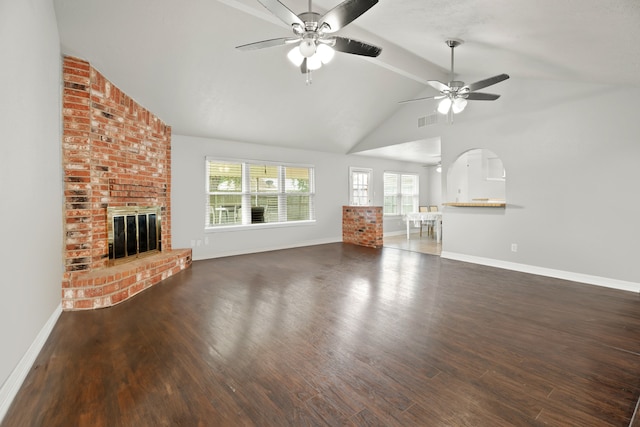 unfurnished living room with ceiling fan, vaulted ceiling, a fireplace, and dark hardwood / wood-style flooring