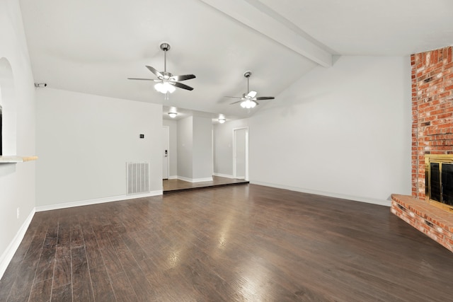 unfurnished living room featuring ceiling fan, a fireplace, lofted ceiling with beams, and dark hardwood / wood-style flooring