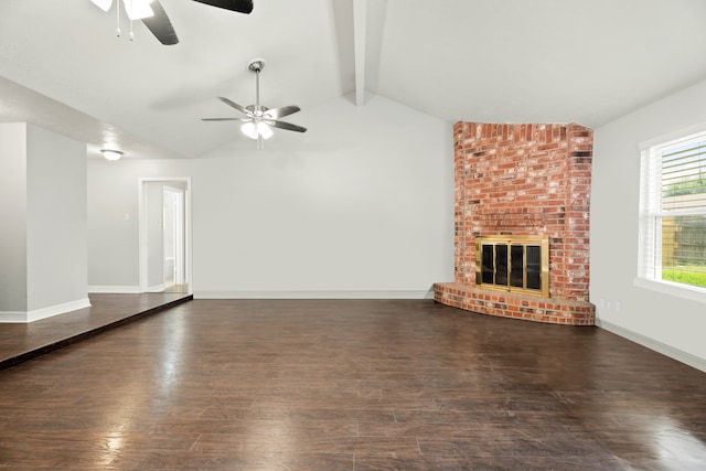 unfurnished living room featuring lofted ceiling with beams, dark hardwood / wood-style floors, ceiling fan, and a brick fireplace