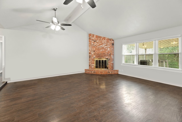 unfurnished living room featuring lofted ceiling with beams, dark hardwood / wood-style flooring, ceiling fan, and a brick fireplace