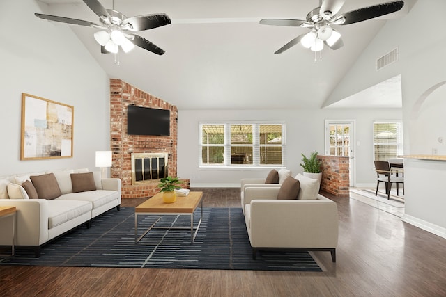 living room with a fireplace, dark hardwood / wood-style floors, and ceiling fan